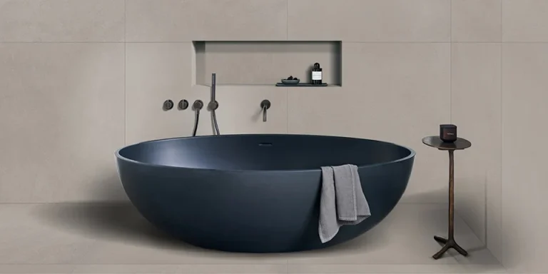 Piet Boon TEXTURE Tile Steel mat in een badkamer met donkerblauw vrijstaand bad